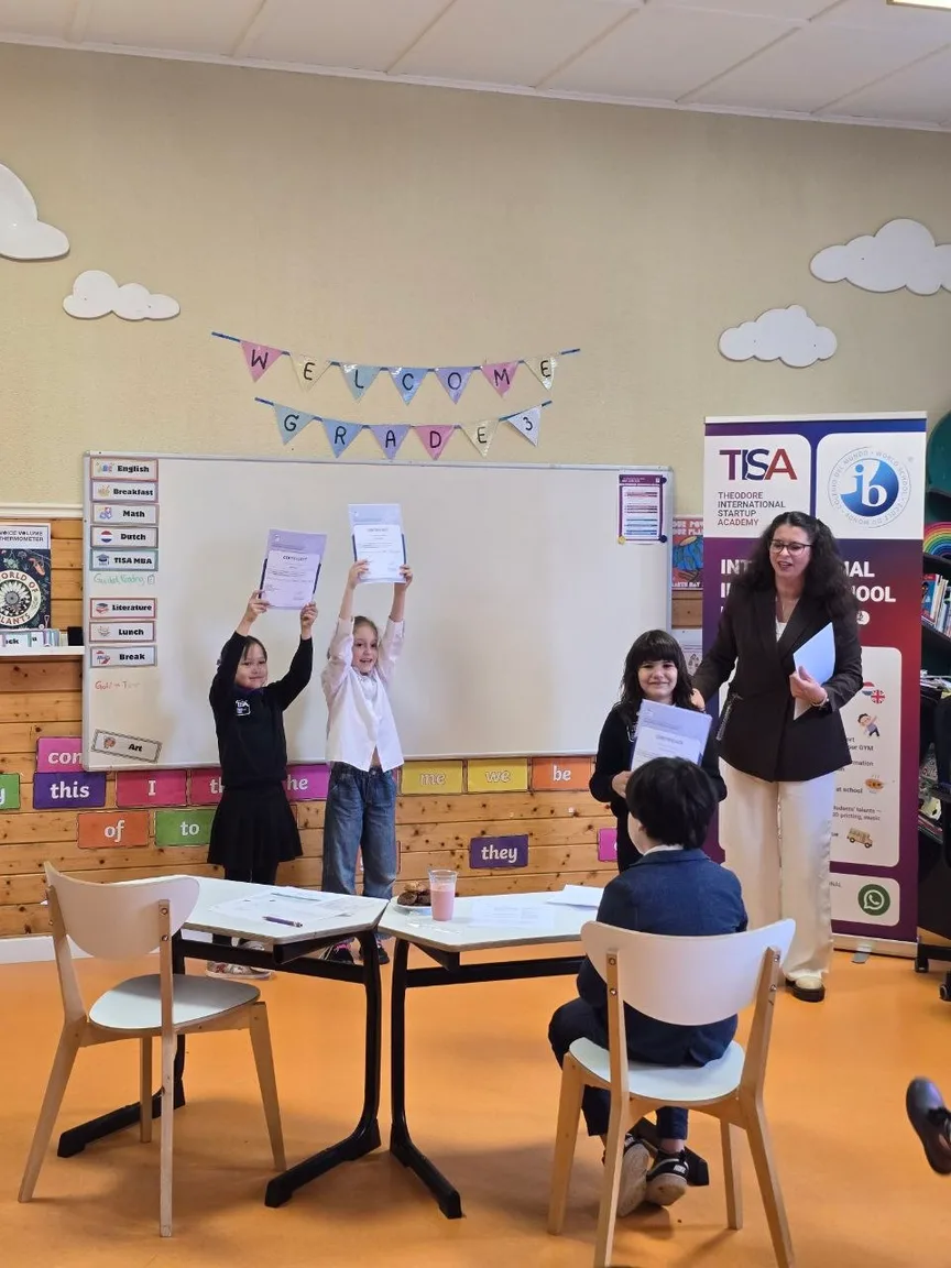 TISA Business students holding certificates with their teacher
