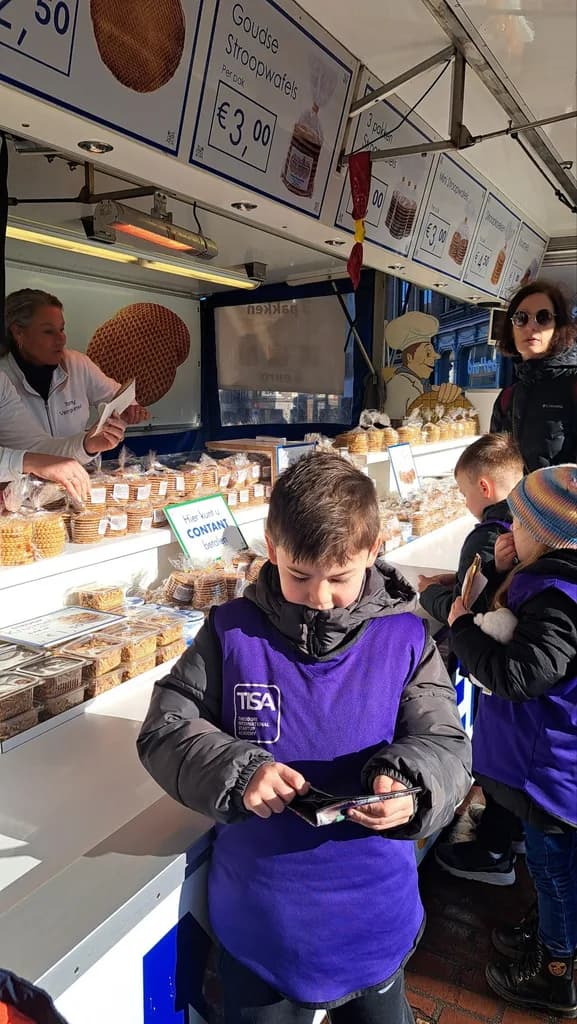 TISA Business student counting money at a real stroopwafel market stall