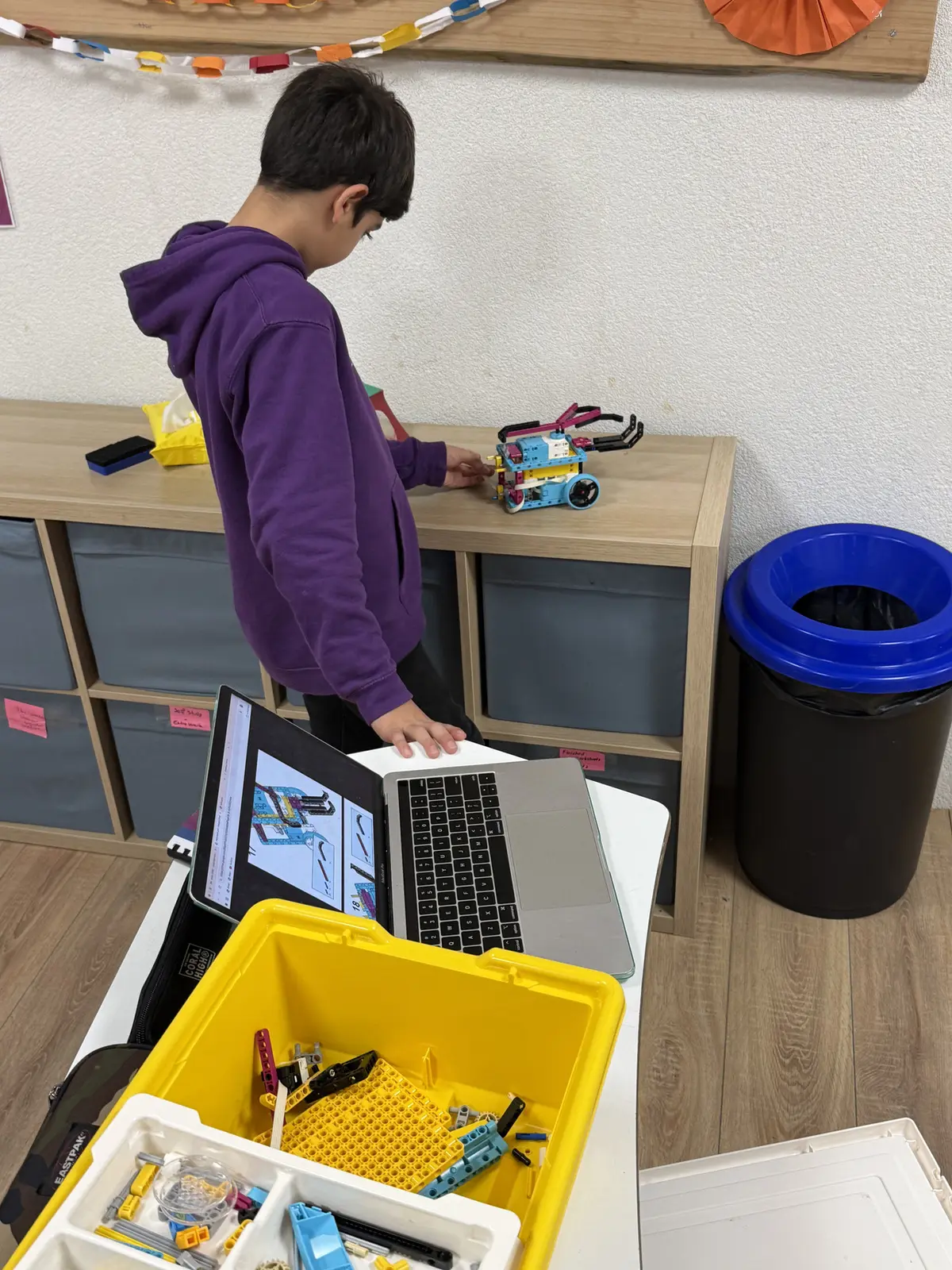 Student programming a robot during a STEM Inventor Lab session at TISA Lisbon