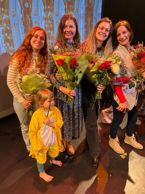 Curtain call with flower bouquets on the TISA theatre stage