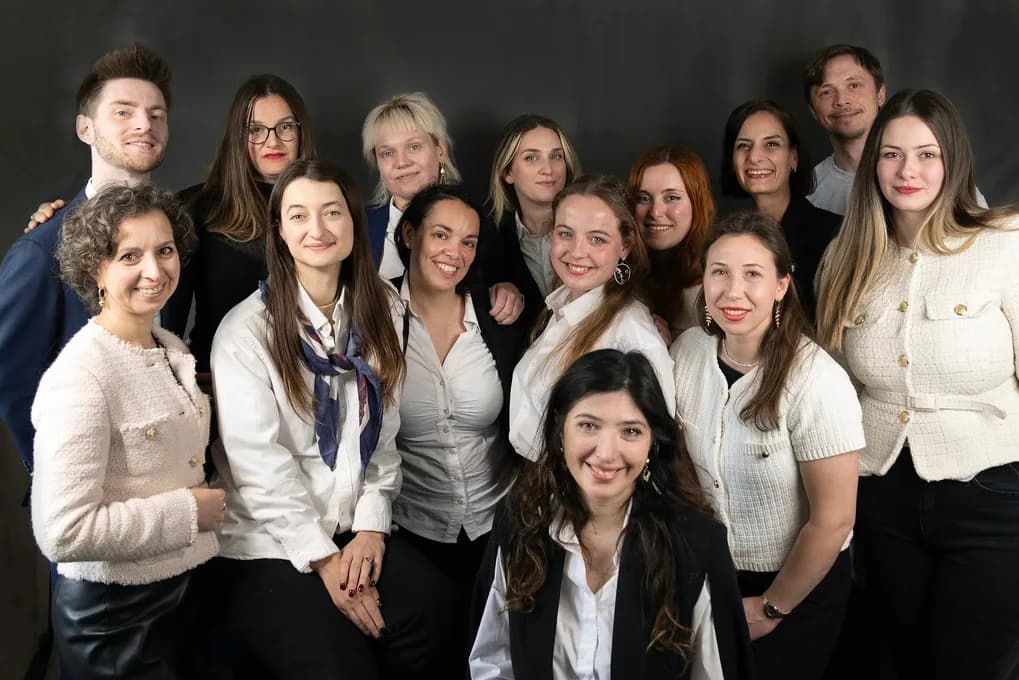 Full TISA teaching staff posed together in a professional studio group photo