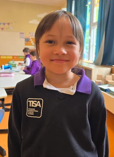 Studio portrait of a smiling young TISA student