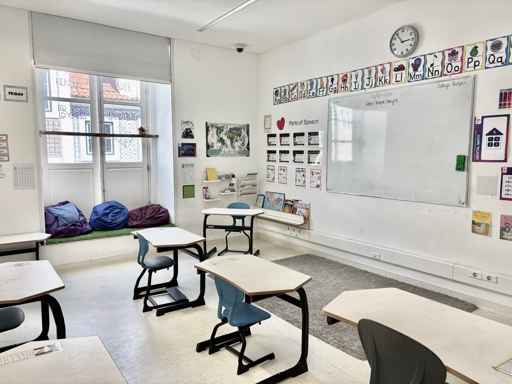 TISA Lisbon classroom with reading corner and azulejo-tiled facade through the window