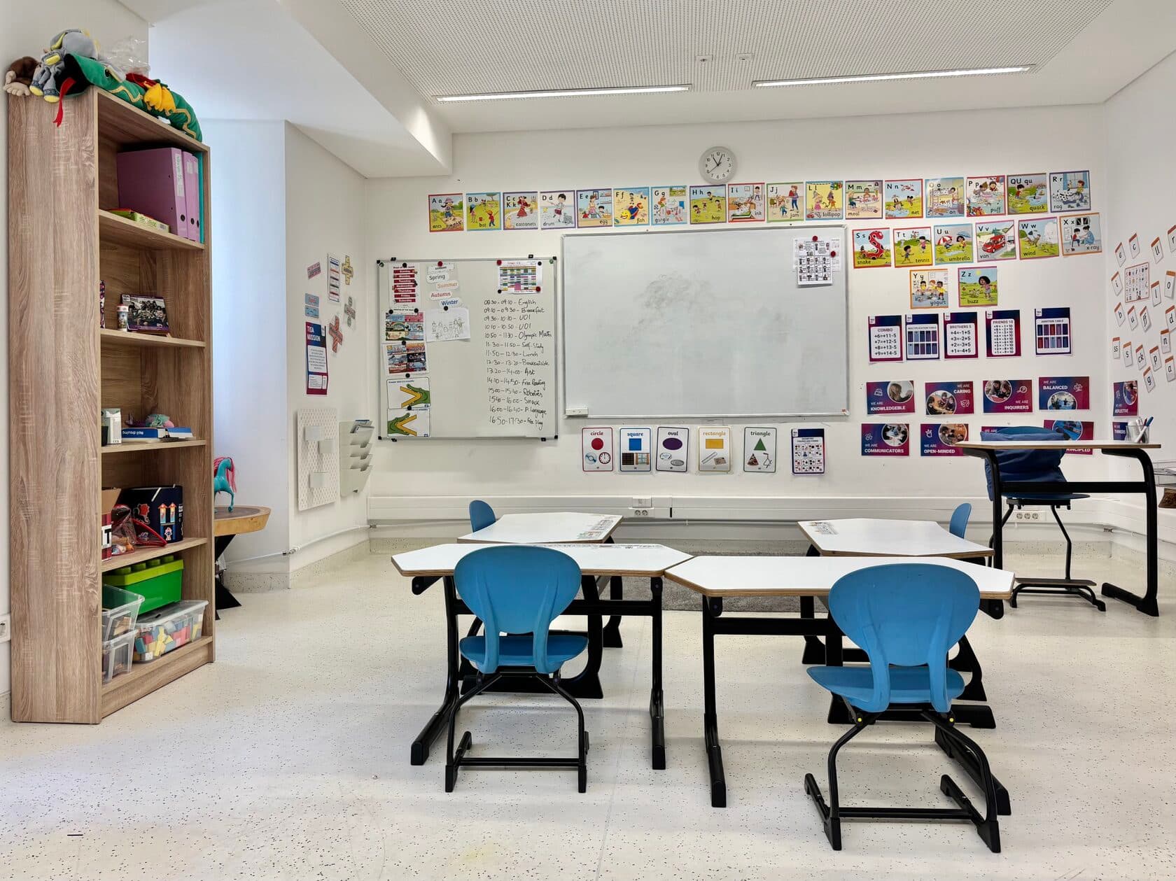 Bright TISA Lisbon classroom with hexagonal desks and blue chairs